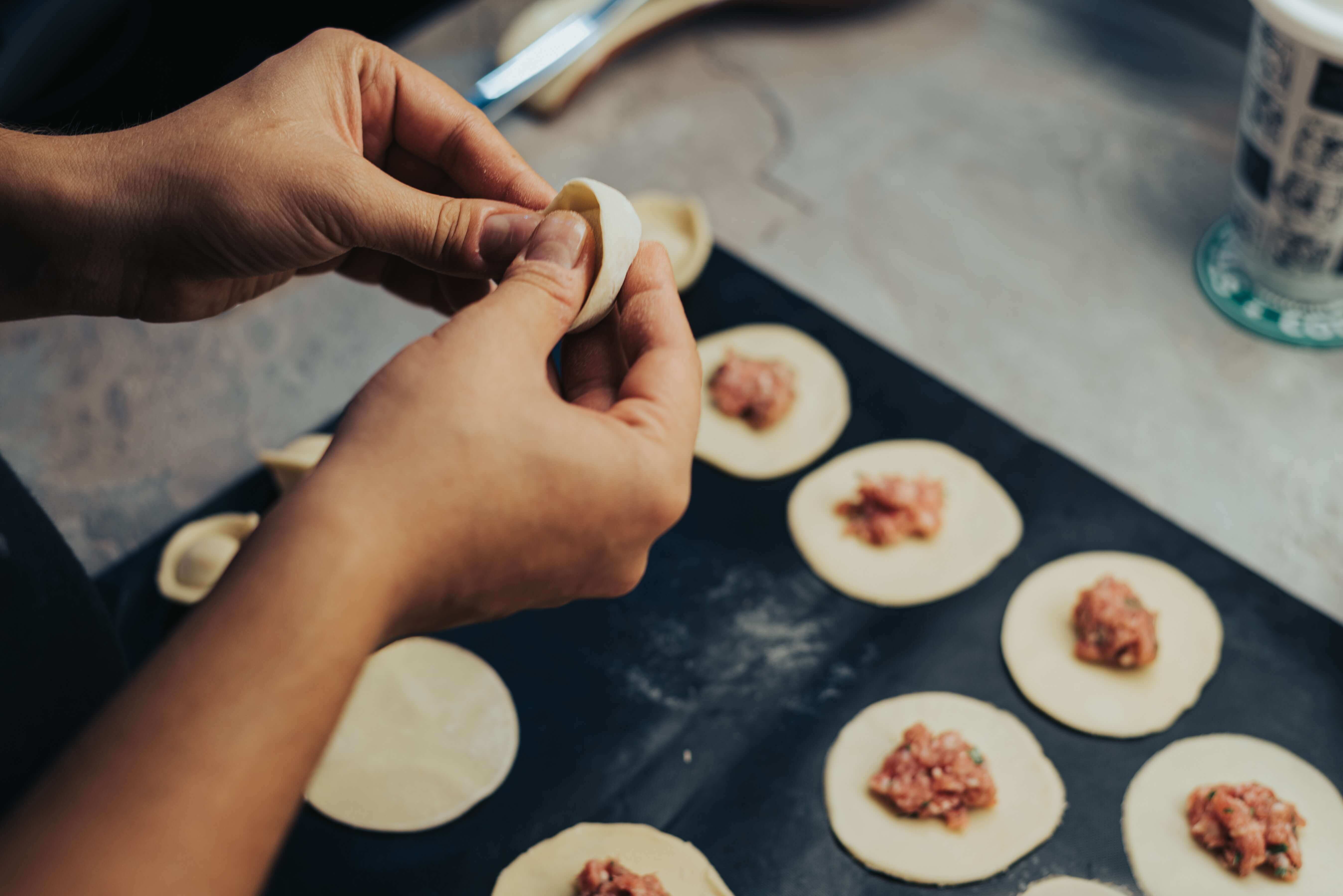 a woman making dumpling